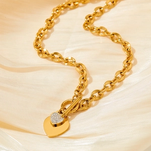 Gold OT toggle necklace with double heart pendants and pavé stones on champagne silk