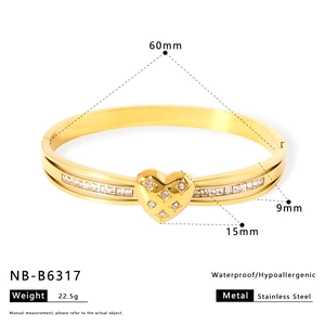 Detailed view of gold heart bangle with measurements and stainless steel material specs