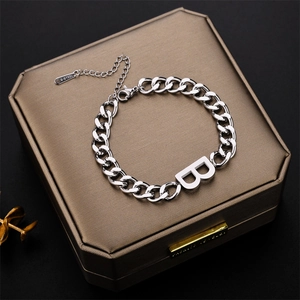 Silver stainless steel curb chain bracelet featuring a prominent capital letter B pendant