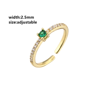 Close-up of 2.5mm adjustable gold ring with green gemstone and micro-pave crystals
