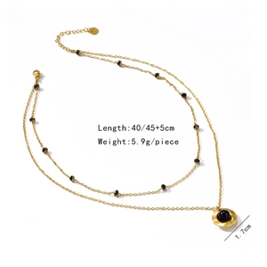 Detailed view of gold double-layer necklace with black pearls and 40/45cm length specs