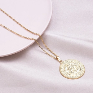 18k gold plated stainless steel necklace with Celtic witch knot pendant on pink silk