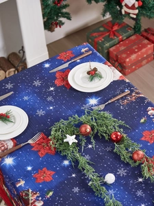 Detailed festive holiday scene with Santa Claus and poinsettia patterns on a blue tablecloth