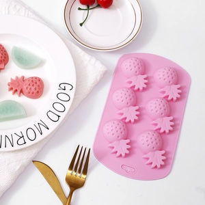 Pink pineapple shaped silicone mold with 8 cavities for making fruit desserts or soap