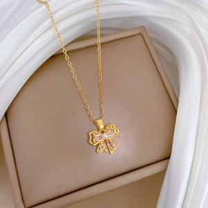 Elegant gold titanium steel necklace featuring a pink bow pendant with pearls on silk