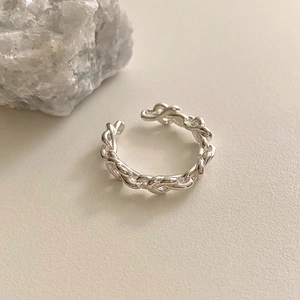 Detail view of a 925 sterling silver open knot ring with a polished twisted rope design