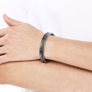 Detail of vintage silver titanium steel bracelet with engraved Chinese characters for luck