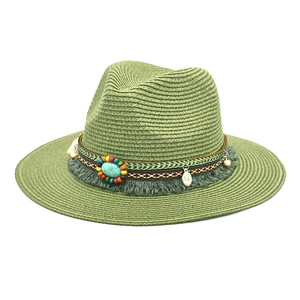 Detail of sage green straw hat with bohemian beaded band and turquoise stone accent
