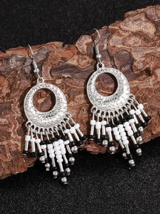Detailed close-up of Bohemian tassel earrings with silver alloy rings and hanging beads