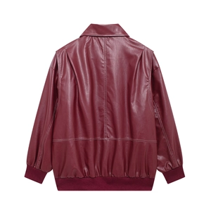 Detail view of the back of a vintage burgundy PU leather jacket with ribbed hem and cuffs