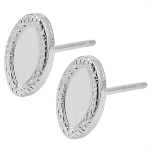 Macro detail of oval stainless steel stud earrings with textured hammered edges