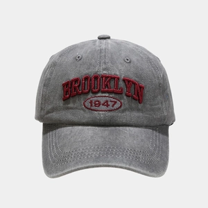 Detail of red BROOKLYN 1947 3D embroidery on washed grey cotton baseball cap
