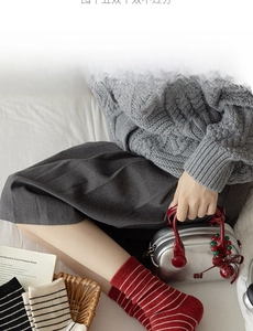 Flat lay of wool striped crew socks with knit sweater and silver handbag for autumn outfit