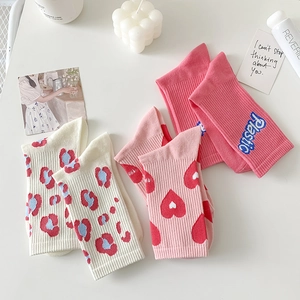 Pink crew socks featuring floral heart designs and Plastic letter patterns for women
