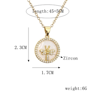 Detailed view of gold dragonfly necklace pendant with size and material specifications