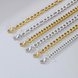 Detailed view of 18K gold and silver Miami and Figaro chain anklets with lobster clasps