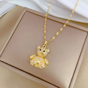 Detail of gold teddy bear pendant with sparkling zircon stones in a jewelry box