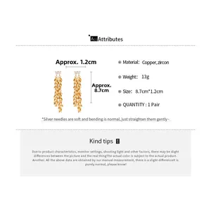 Detailed view of gold leaf tassel earrings with zircon inlay and product dimensions