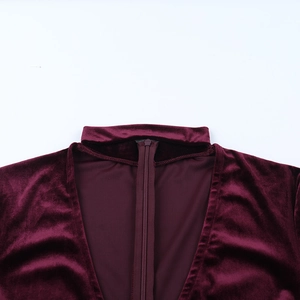 Close-up of invisible back zipper and fine velvet texture on burgundy bodysuit