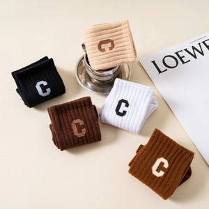 Detailed view of five-color ribbed knit crew socks with letter C embroidery and soft texture