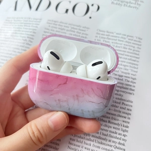 Pink and blue gradient marble texture case for AirPods Pro held in hand with open lid