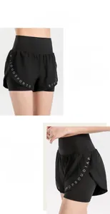 Detail of black double-layer athletic shorts featuring stylish letter print on the hem