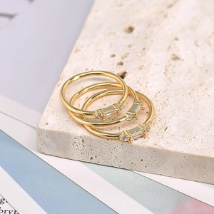 Close-up of three-piece 18k gold plated ring set with stacked white zircon stones