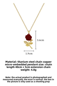 Detailed view of red rose pendant with gold leaves and micro-inlaid rhinestones