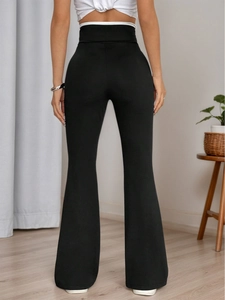 Slim fit high waisted black flared yoga pants showing butt lifting effect and leg silhouette