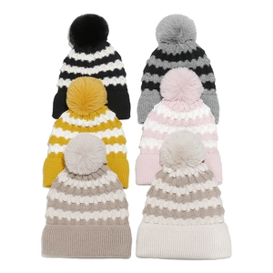 Winter striped knit beanies with faux fur pom-poms shown in six assorted color options