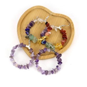 Handmade bohemian hoop earrings with colorful natural crushed stones in a wooden tray