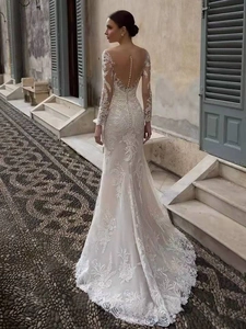 Detail of elegant backless mermaid wedding dress with lace lace and pearl buttons