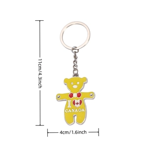 Detailed size view of yellow bear metal keychain with I Love Canada logo and enamel finish
