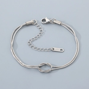 Detail of silver double-layered snake chain bracelet with knot made of stainless steel