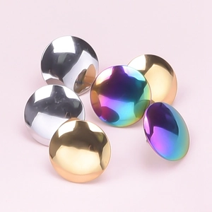 Macro shot of 304 stainless steel studs in polished silver, gold, and rainbow finishes