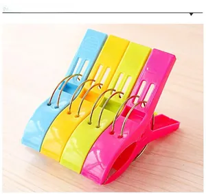 Detailed macro of large colorful plastic laundry pegs with strong metal springs