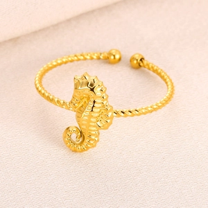 Detailed macro view of a gold seahorse adjustable bangle with a twisted rope texture