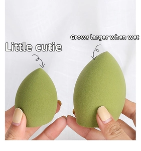 Detail of green makeup sponge showing size comparison before and after soaking in water