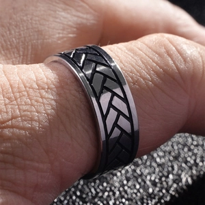 Men's titanium steel ring featuring a bold woven texture in silver and black finish