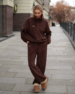 Detail of dark brown fleece track set showing zip cardigan and wide leg joggers embroidery