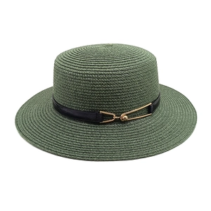 Detail of dark green straw hat featuring black leather band and gold horseshoe buckle