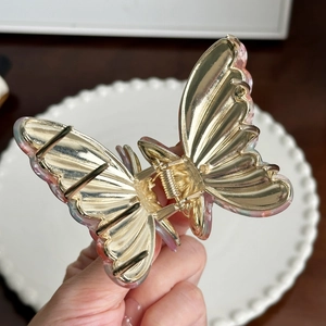 Elegant butterfly hair claw clip with pink purple iridescent finish and golden metal spring