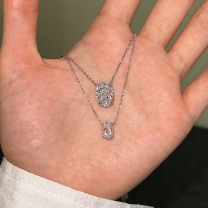 Close-up of S925 sterling silver necklaces with oval cut perfume bottle pendants