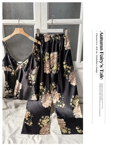 Detail of floral satin sleepwear set featuring a V-neck camisole and wide-leg trousers