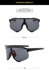 Detail of sports sunglasses featuring shiny black frame with gray lens and red nose pads