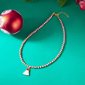Detailed view of red and white beaded necklace with Christmas tree pendant and golden clasp