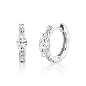 Detailed macro view of marquise-cut crystal and micro-pave diamonds on silver huggie earrings