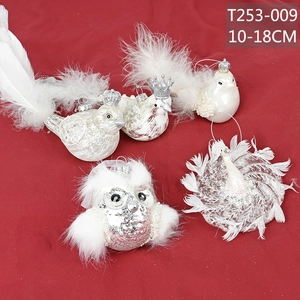 Detail of Christmas bird ornaments with pink pearl finish and white faux feathers