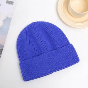 Flat lay of soft chunky knit beanie in royal blue with textured fold-over cuff detail