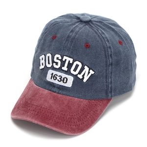 Detailed view of white Boston 1630 3D embroidery on washed denim baseball cap